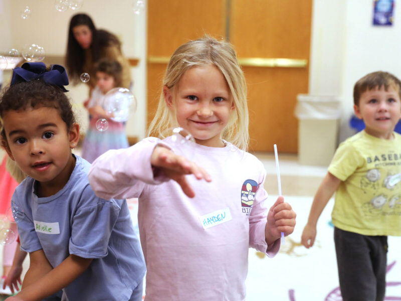 Four young children smile and play with bubbles during a "Preschool Pioneers" early learning program at Museum of the Rockies.